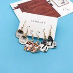 Cat-themed drop earrings close-up