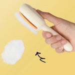 Push-button fur release on the cat grooming brush