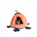 A tabby cat rests inside the Orange Armarkat pumpkin cat cave