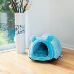 Cornflower Blue Armarkat cat-ear bed placed beside a window
