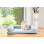 A cream cat sits on the Blue Medium Armarkat D08A bolstered pet bed
