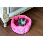 A gray kitten sits in an Armarkat Pink velvet cuddle bed