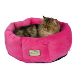 A longhaired cat rests in an Armarkat Pink velvet cuddle bed