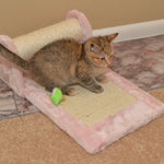 A cat rests on the pink Armarkat X0602 scratching station beneath its sisal-covered roller