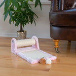 Pink Armarkat compact scratching station beside a chair