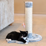 A tuxedo cat rests beside the sisal post on an Armarkat mouse-shaped scratcher