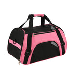 Pink soft-sided cat travel carrier with black mesh panels and carry handles