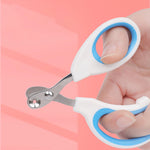 Hand holding white and blue cat nail scissors with circular blade opening
