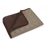 Brown fabric cat resting mat with a folded corner showing the backing