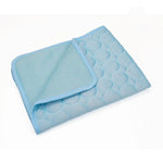 Light blue fabric cat resting mat with a folded corner showing the backing