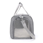 End view of the gray cat carrier showing its zipped mesh panel and shoulder strap.