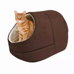 An orange tabby sits inside the Coffee GOOPAWS covered cat cave bed
