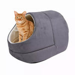 An orange tabby sits inside the Gray GOOPAWS covered cat cave bed