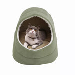 A gray and white cat rests inside the Sage Green GOOPAWS cat cave, viewed from the front