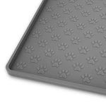 Gray rubber cat feeding mat with raised paw-print texture and a low border.