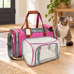 Rosa pink Mr. Peanut’s Gold Mini expandable cat carrier with its mesh expansion open and a cat sitting beside it