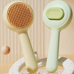Front and back of the yellow and green cat grooming brushes