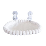 Front view of the cream oval cat window hammock with its padded edge and suction-cup mounts.