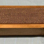 Wooden frame and cardboard scratching surface viewed from the side